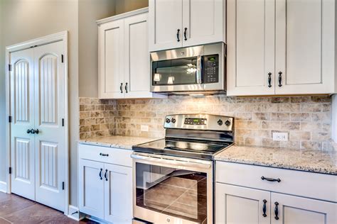 Kitchen with White Cabinets and Stainless Steel Countertops 